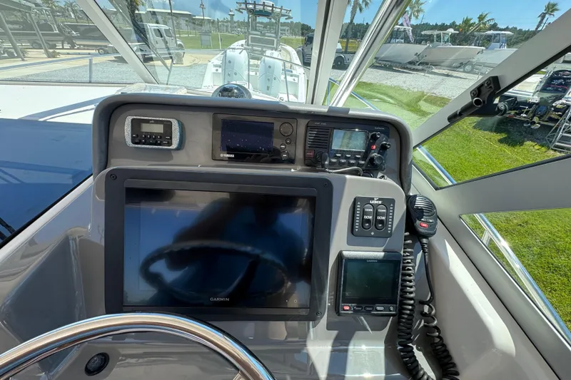 Slide: The Image of Control panel of a 2015 Pursuit OS 285 Offshore boat with navigation equipment. - 21