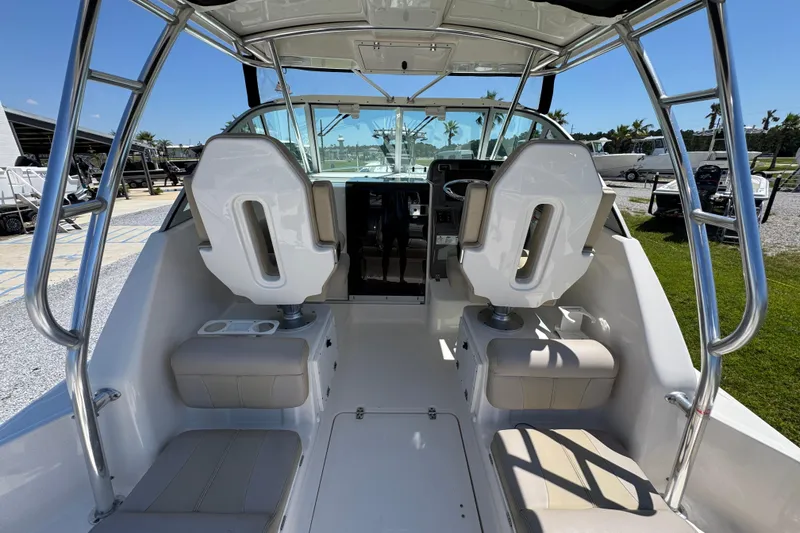 Slide: The Image of 2015 Pursuit OS 285 Offshore boat interior with seating and helm, showcasing modern design. - 24