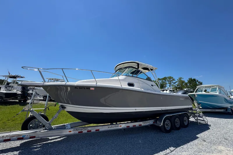 Slide: The Image of 2015 Pursuit OS 285 Offshore boat on trailer under clear blue sky. - 3
