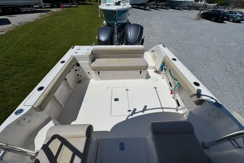 Slide: The Image of 2015 Pursuit OS 285 Offshore boat interior with seating and storage compartments. - 33