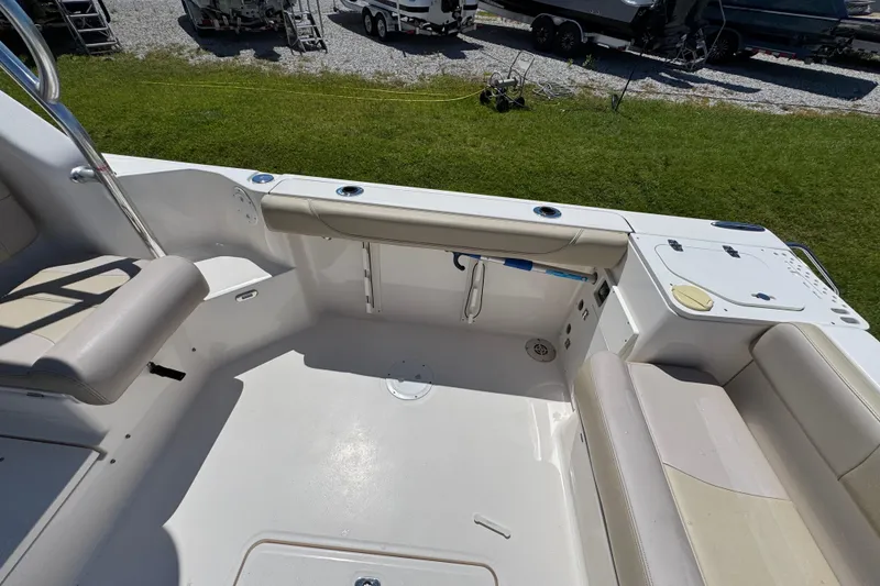 Slide: The Image of 2015 Pursuit OS 285 Offshore boat interior with seating and fishing rod holders. - 35