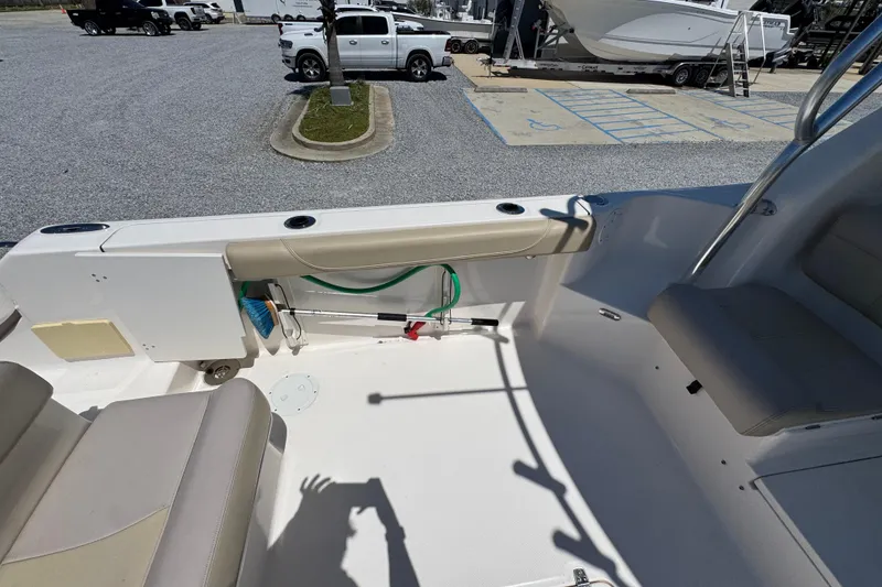 Slide: The Image of 2015 Pursuit OS 285 Offshore boat interior with seating and storage area. - 36