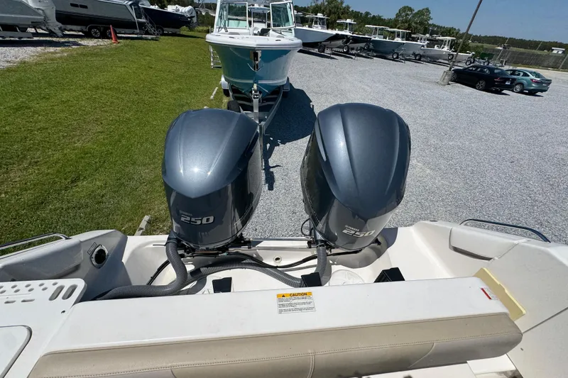 Slide: The Image of 2015 Pursuit OS 285 Offshore boat with dual Yamaha 250 engines in a marina setting. - 37