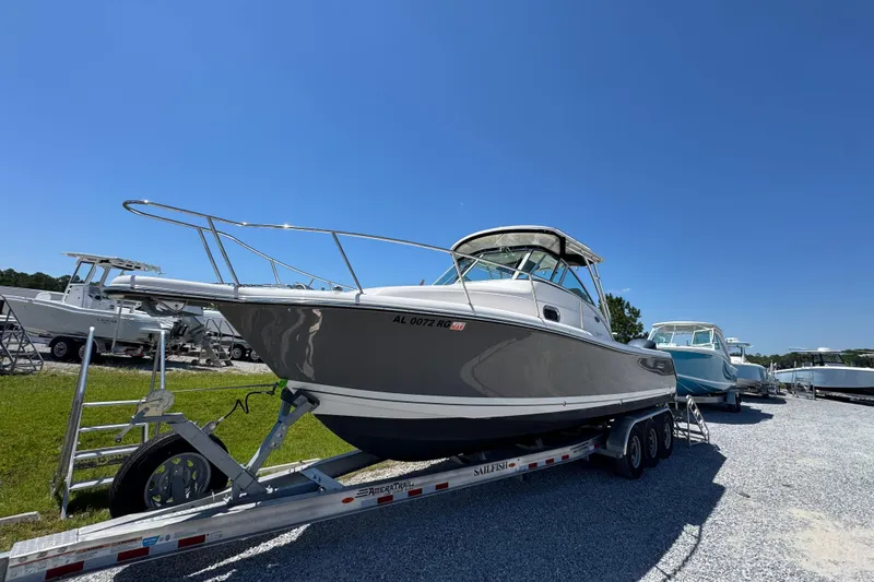 Slide: The Image of 2015 Pursuit OS 285 Offshore boat on trailer under clear blue sky. - 4