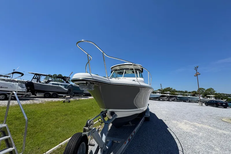 Slide: The Image of 2015 Pursuit OS 285 Offshore boat on trailer under clear blue sky. - 6