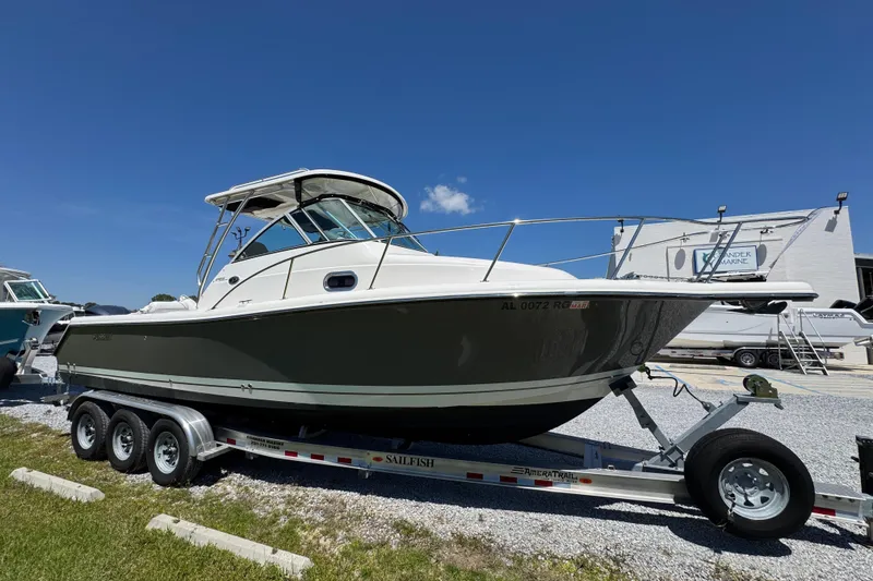 Slide: The Image of 2015 Pursuit OS 285 Offshore boat on trailer under clear blue sky. - 8