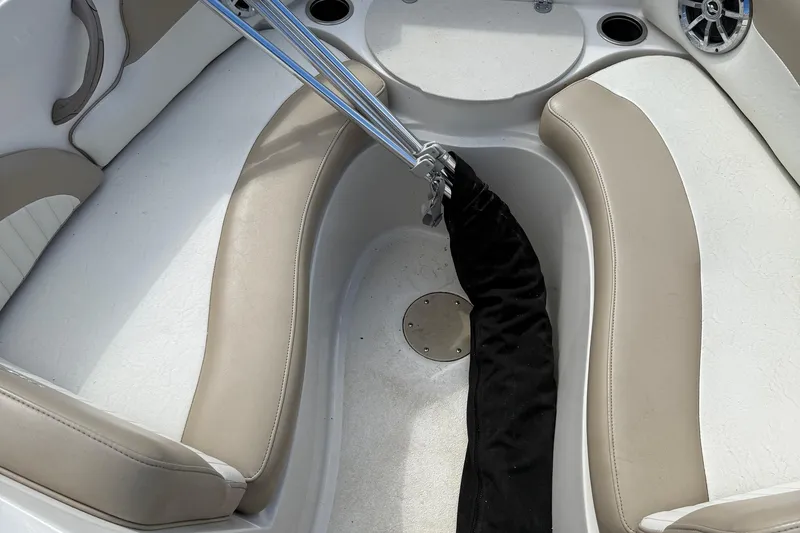 Slide: The Image of Interior of a 2014 Stingray 208 LR boat with beige seating and storage area. - 11