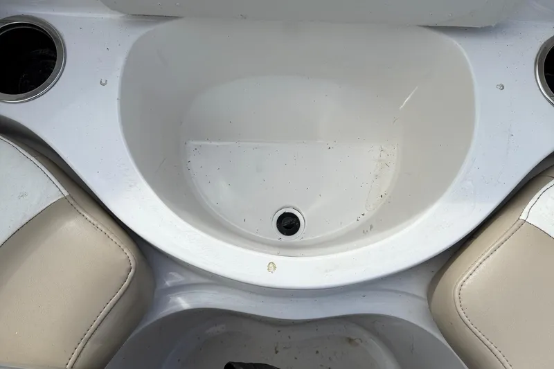 Slide: The Image of Interior of a 2014 Stingray 208 LR boat with cup holders and seating. - 14