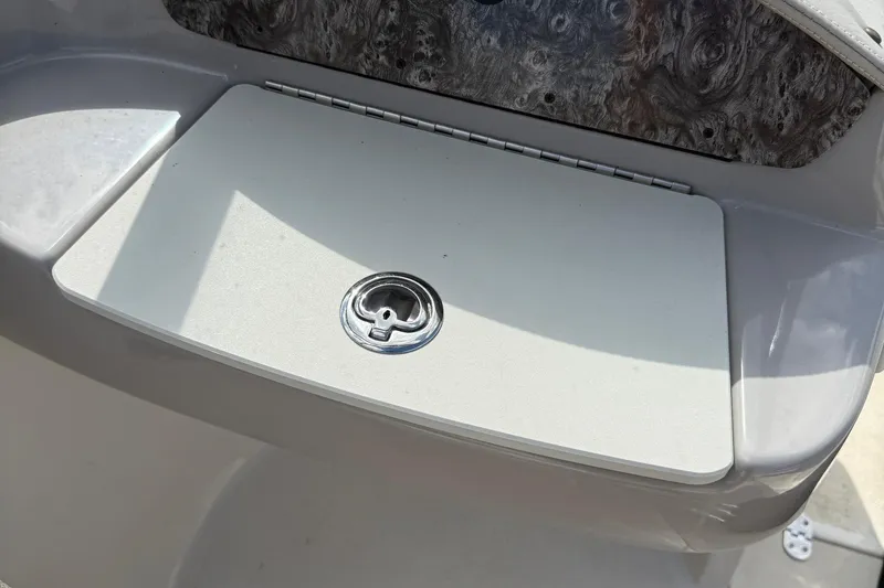 Slide: The Image of 2014 Stingray 208 LR boat storage compartment with a secure latch. - 23
