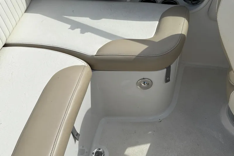 Slide: The Image of 2014 Stingray 208 LR boat interior with beige seating and white flooring. - 24