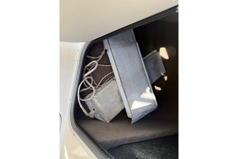 Slide: The Image of Storage compartment of 2014 Stingray 208 LR boat with ropes and equipment. - 27