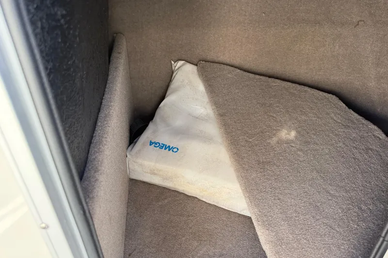 Slide: The Image of Storage compartment in 2014 Stingray 208 LR boat with Omega-branded cushion. - 28