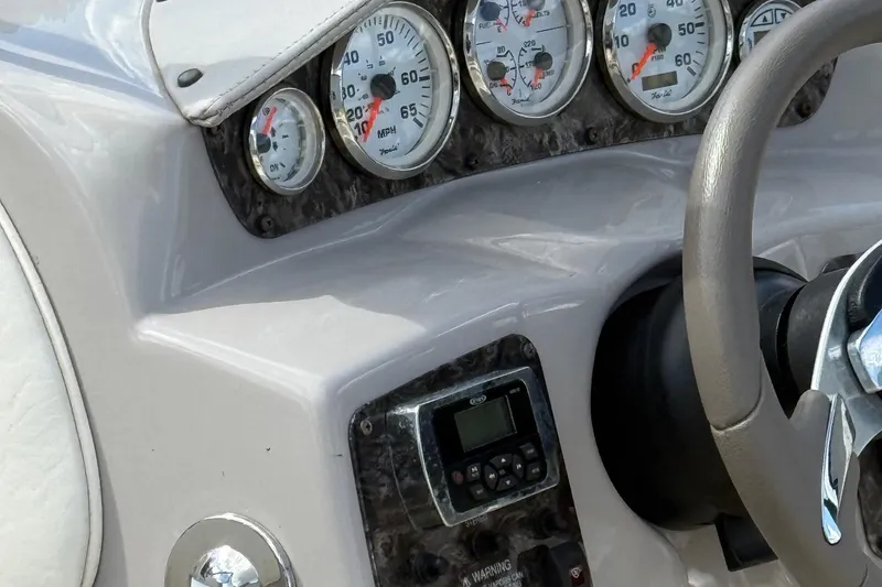 Slide: The Image of Dashboard of a 2014 Stingray 208 LR boat with gauges and steering wheel. - 8