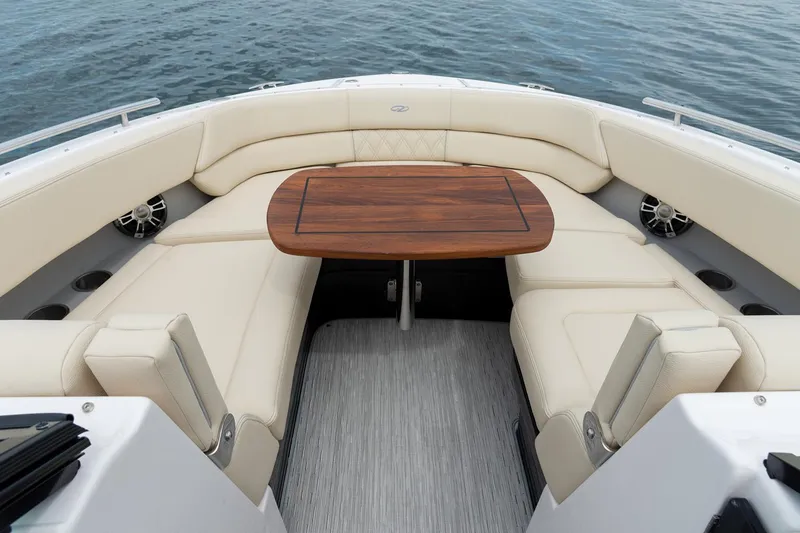 Slide: The Image of 2022 Regal 2800 Bowrider interior with white seating, docked by the water. - 13