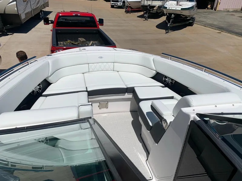 Slide: The Image of 2022 Regal 2800 Bowrider docked on a sunny day by the lake. - 2