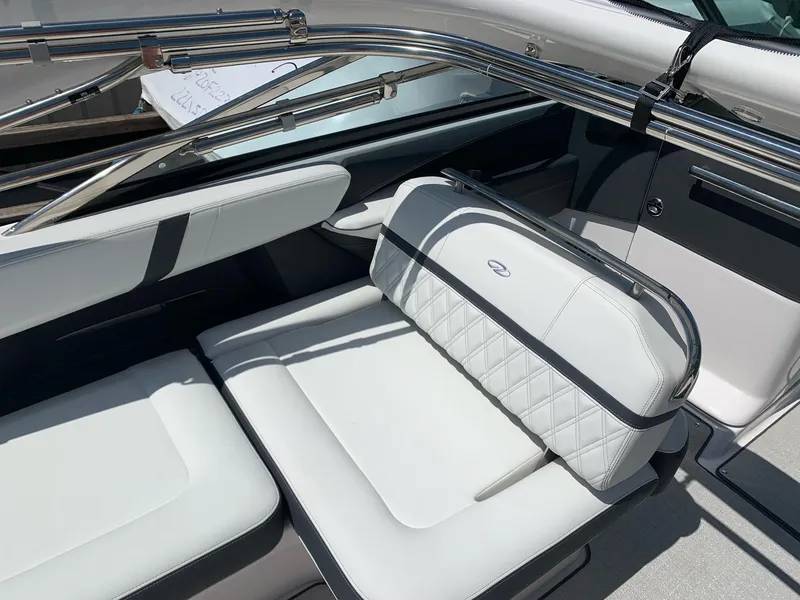 Slide: The Image of 2022 Regal 2800 Bowrider boat, rear view, showcasing spacious deck and seating. - 3