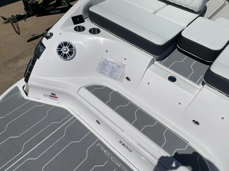 Slide: The Image of 2022 Regal 2800 Bowrider boat with sleek deck design on calm water. - 4
