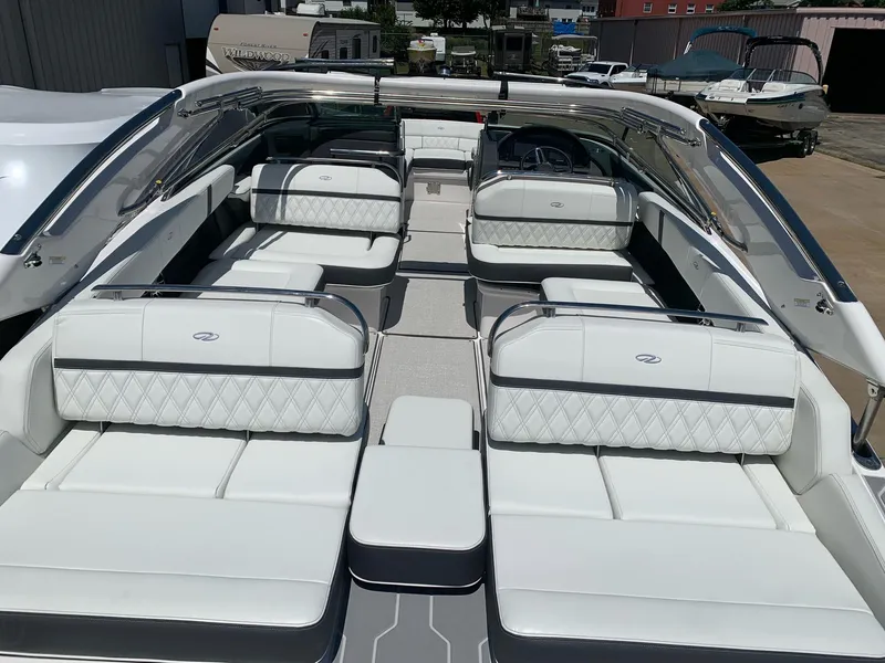 Slide: The Image of 2022 Regal 2800 Bowrider boat with luxurious seating on calm water. - 5