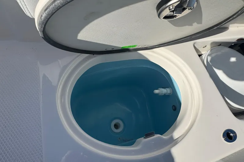 Slide: The Image of Livewell on 2026 Robalo R202 Explorer boat, open lid, blue interior. - 14