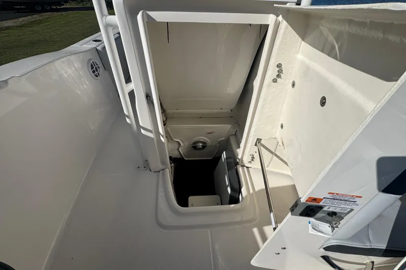Slide: The Image of 2026 Robalo R202 Explorer boat interior storage compartment, open hatch view. - 21