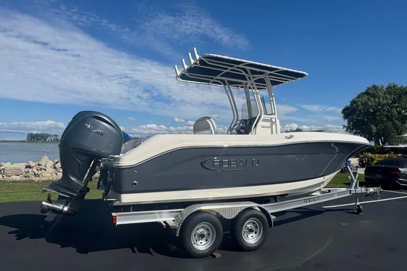 Slide: The Image of 2026 Robalo R202 Explorer boat on trailer by a lake under blue sky. - 3