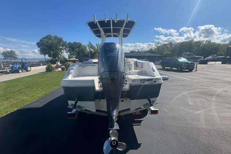Slide: The Image of 2026 Robalo R202 Explorer boat with powerful outboard motor in a sunny marina setting. - 4