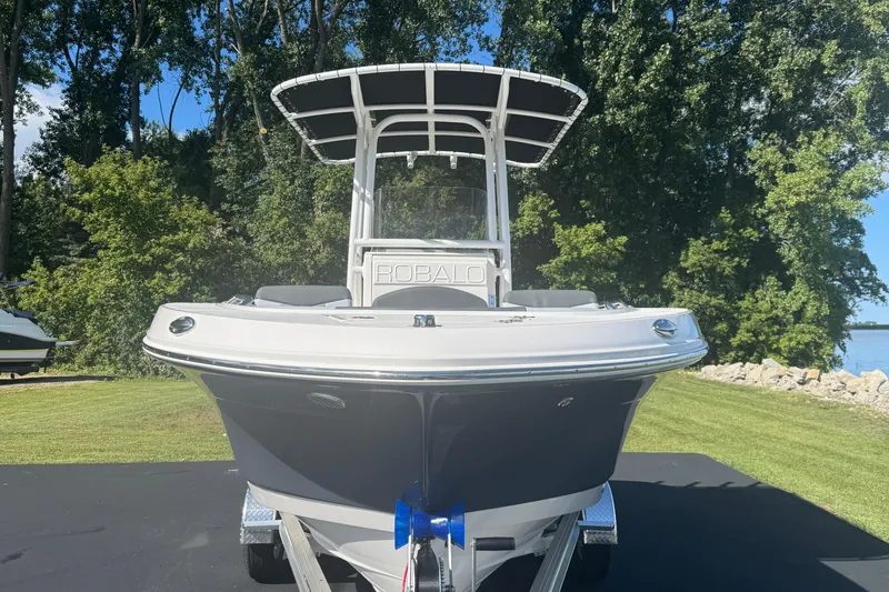 Slide: The Image of 2026 Robalo R202 Explorer boat on trailer, surrounded by lush greenery. - 5