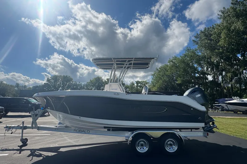Slide: The Image of 2026 Robalo R202 Explorer boat on trailer under sunny sky. - 6