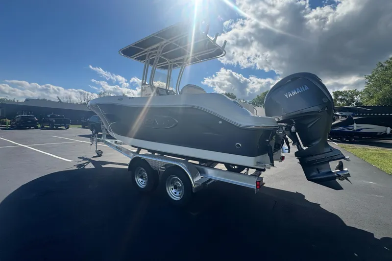 Slide: The Image of 2026 Robalo R202 Explorer boat with Yamaha engine on trailer under sunny sky. - 8