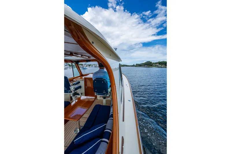 Slide: The Image of 2017 Hinckley Picnic Boat 37 MKIII cruising on a scenic waterway under a blue sky. - 11