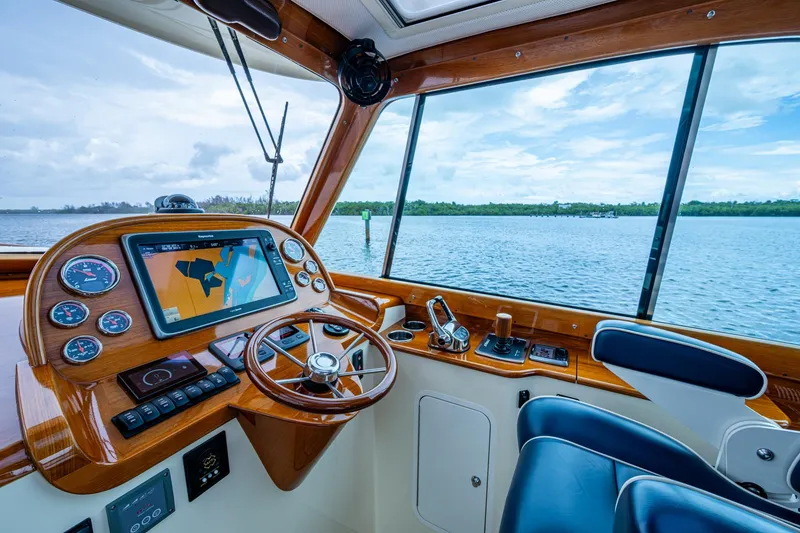 Slide: The Image of 2017 Hinckley Picnic Boat 37 MKIII helm with navigation system and scenic water view. - 13