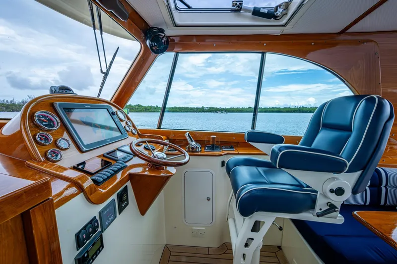 Slide: The Image of 2017 Hinckley Picnic Boat 37 MKIII helm with luxurious seating and navigation controls. - 14