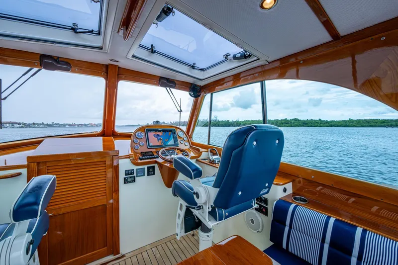 Slide: The Image of Interior of 2017 Hinckley Picnic Boat 37 MKIII with helm and scenic water view. - 15