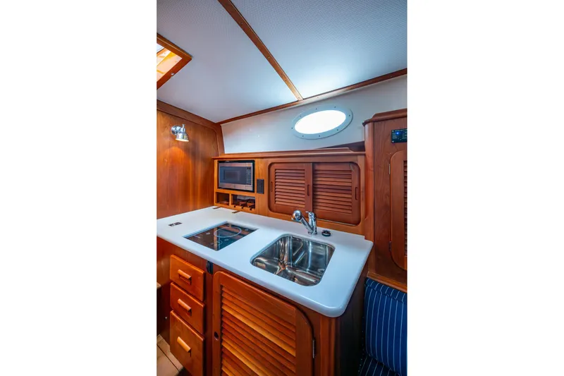 Slide: The Image of 2017 Hinckley Picnic Boat 37 MKIII galley with sink, stove, and microwave. - 19