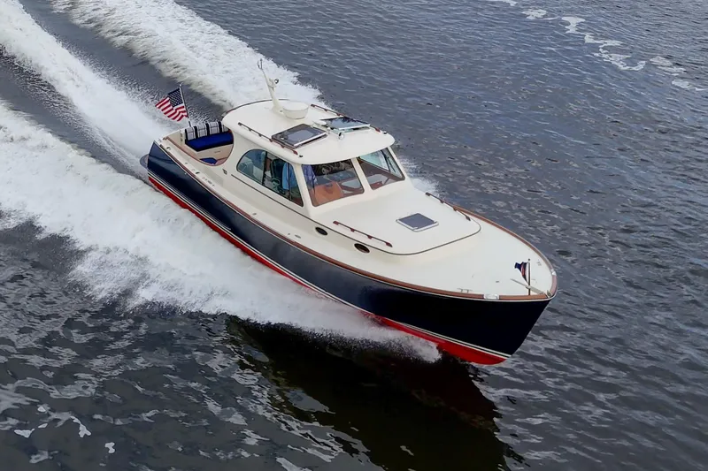 Slide: The Image of 2017 Hinckley Picnic Boat 37 MKIII cruising on open water. - 2