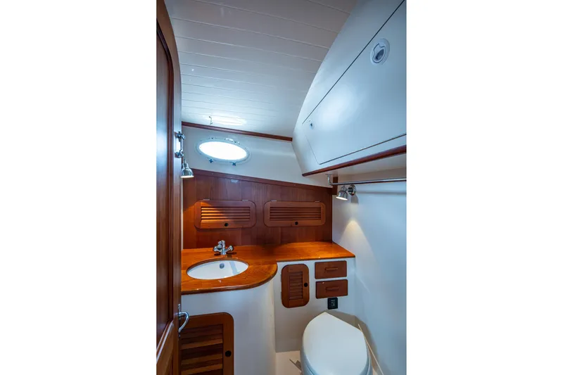 Slide: The Image of Hinckley Picnic Boat 37 MKIII 2017 bathroom with wooden cabinetry and modern fixtures. - 24