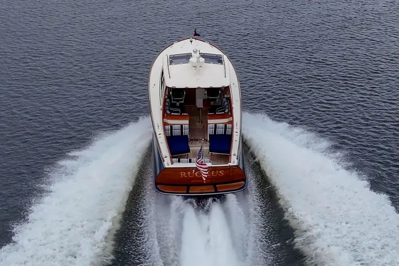 Slide: The Image of 2017 Hinckley Picnic Boat 37 MKIII cruising on open water, rear view. - 30