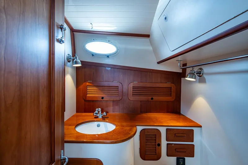 Slide: The Image of Luxurious wooden interior of 2017 Hinckley Picnic Boat 37 MKIII bathroom with sink and lighting. - 22