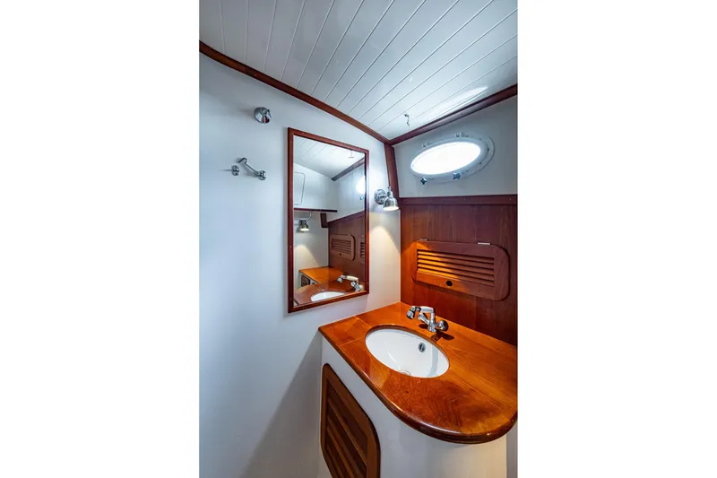 Slide: The Image of Elegant bathroom interior of 2017 Hinckley Picnic Boat 37 MKIII with wooden accents. - 25