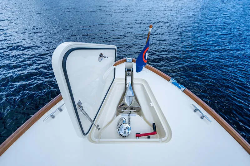 Slide: The Image of Hinckley Picnic Boat 37 MKIII 2017 bow with anchor hatch open on calm water. - 26