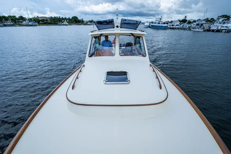 Slide: The Image of 2017 Hinckley Picnic Boat 37 MKIII cruising on a calm waterway. - 27