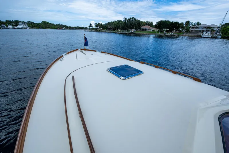 Slide: The Image of 2017 Hinckley Picnic Boat 37 MKIII on serene waterway, clear sky above. - 28