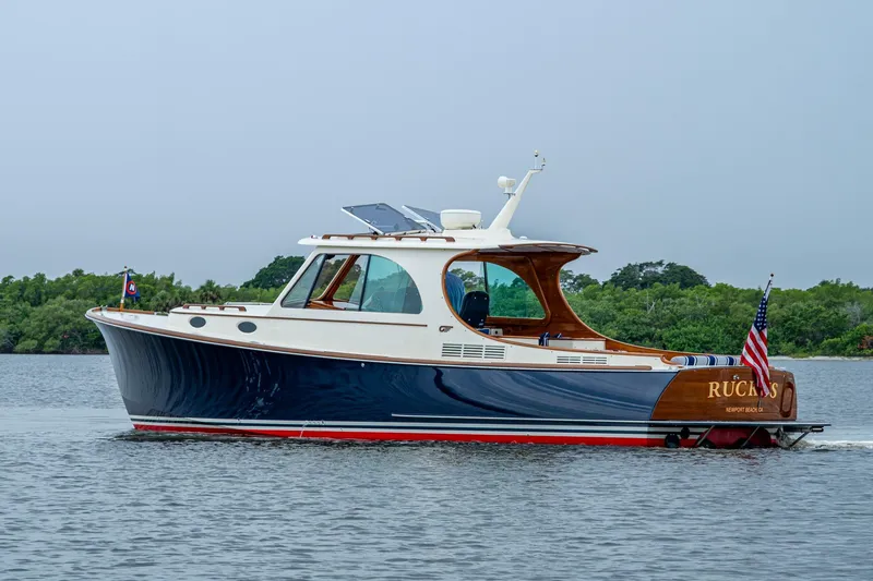 Slide: The Image of 2017 Hinckley Picnic Boat 37 MKIII cruising on calm waters, displaying elegant design. - 3
