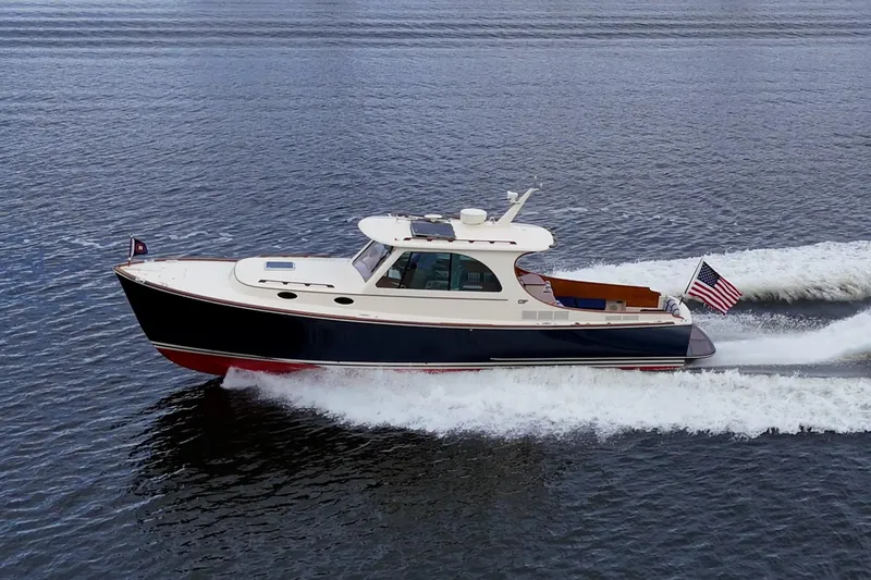 Slide: The Image of 2017 Hinckley Picnic Boat 37 MKIII cruising on open water, American flag displayed. - 31