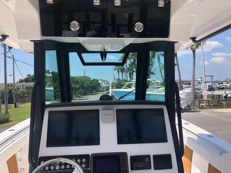 Slide: The Image of 2025 Caymas 30 CT boat dashboard with modern navigation screens and controls. - 13