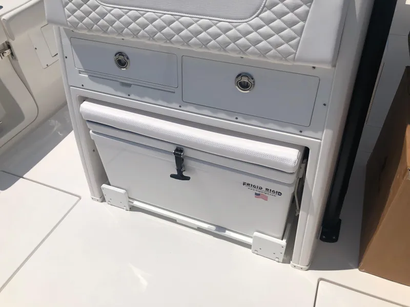 Slide: The Image of 2025 Caymas 30 CT boat interior with storage drawers and cooler. - 27