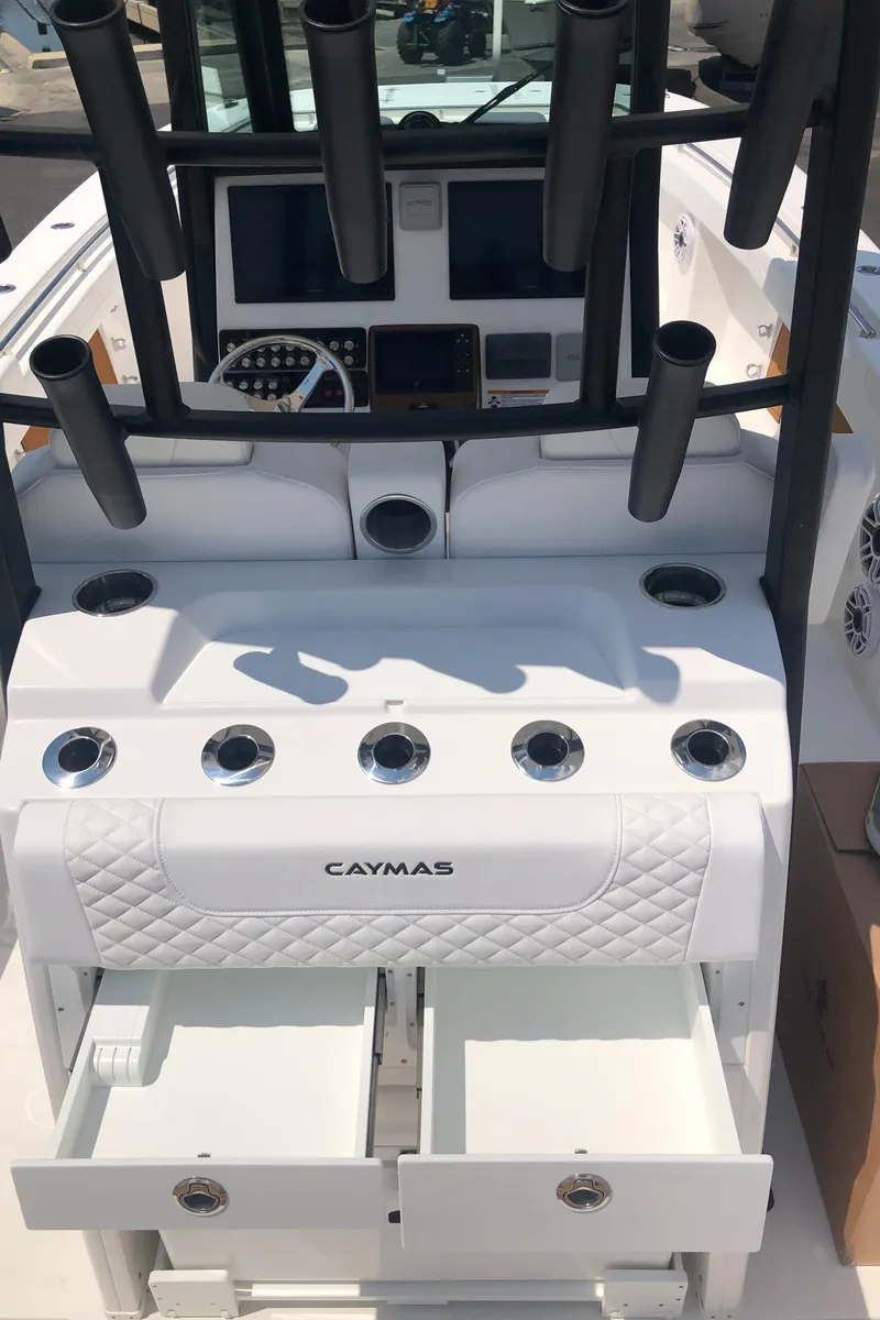 Slide: The Image of 2025 Caymas 30 CT boat dashboard with rod holders and storage compartments. - 34