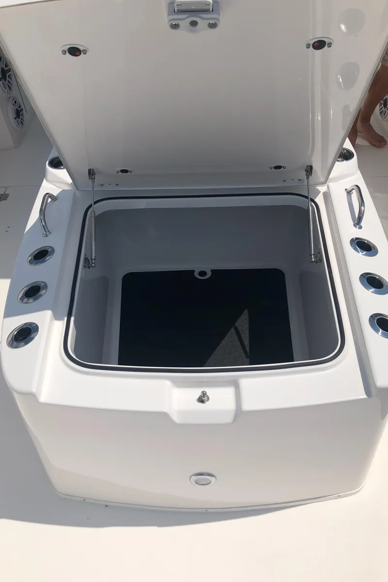 Slide: The Image of 2025 Caymas 30 CT boat storage compartment with open lid. - 38