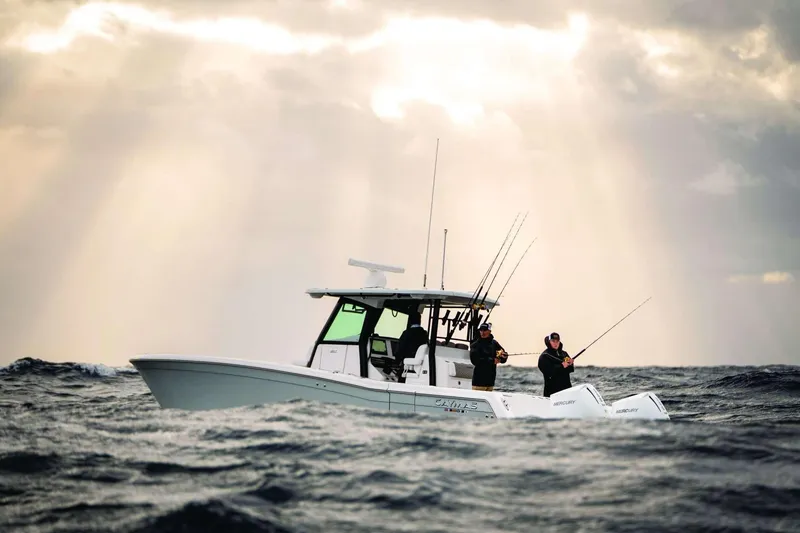 Slide: The Image of 2026 Caymas 30 CT boat with anglers fishing on open sea under dramatic sky. - 42