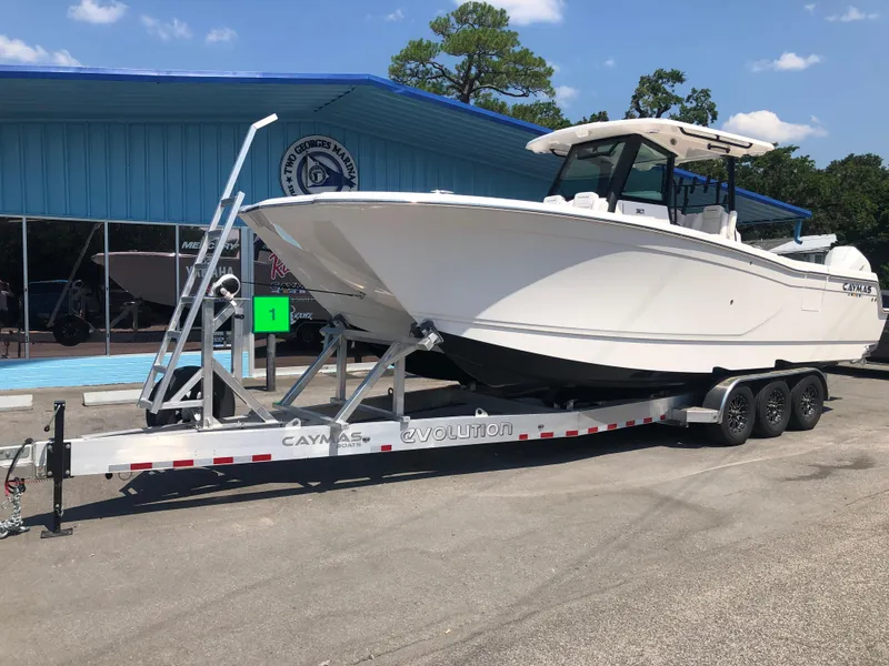 Slide: The Image of 2025 Caymas 30 CT boat on trailer outside dealership. - 6